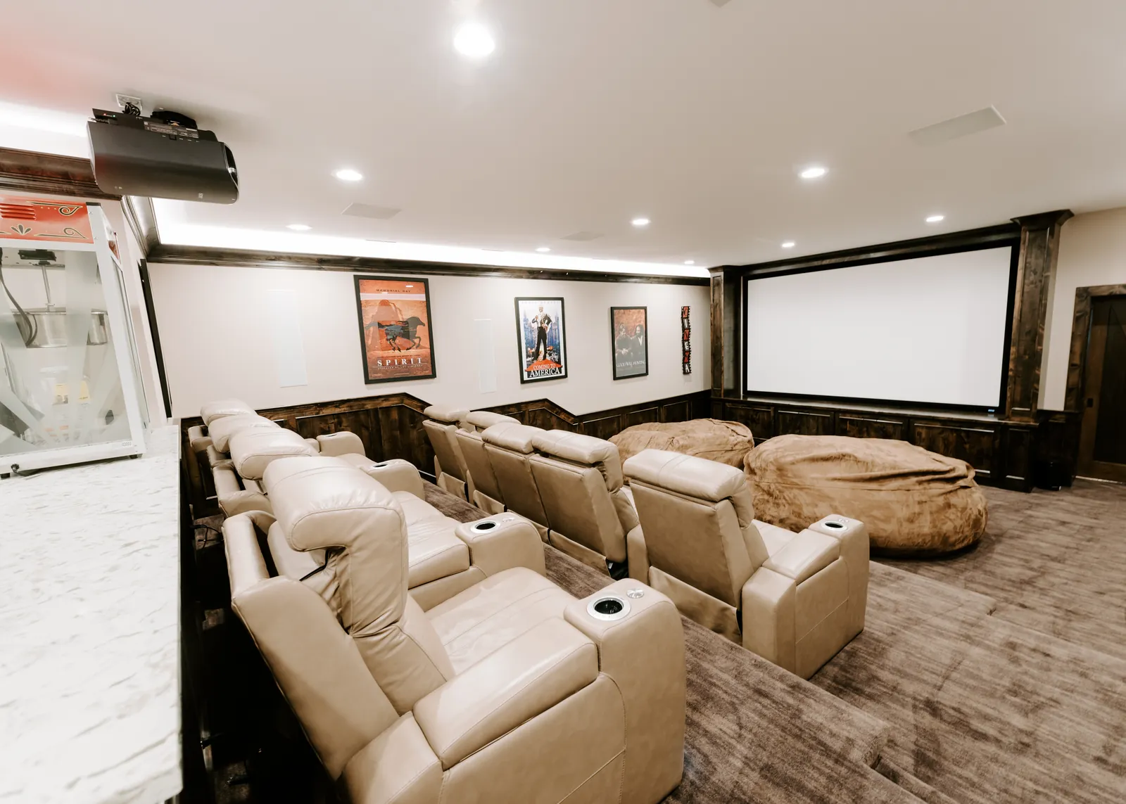 Finished private home theater with projection screen and tiered seating