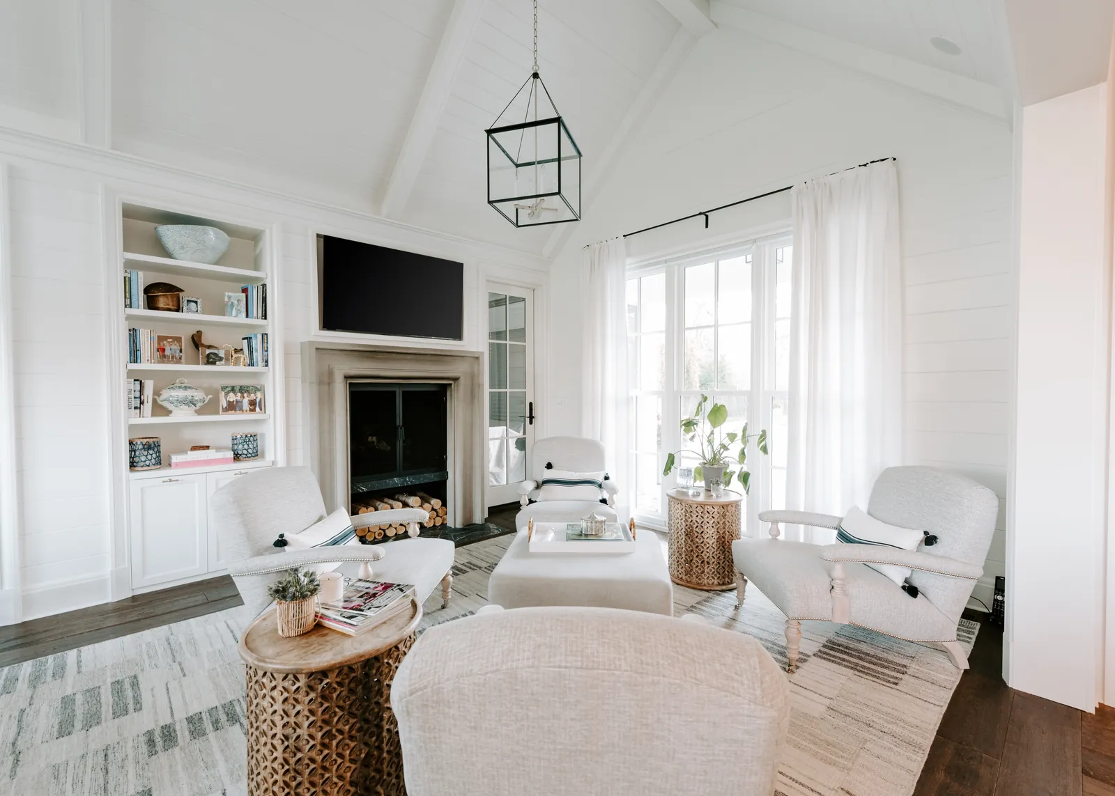 Bright living room with built-in shelving and a wall-mounted television