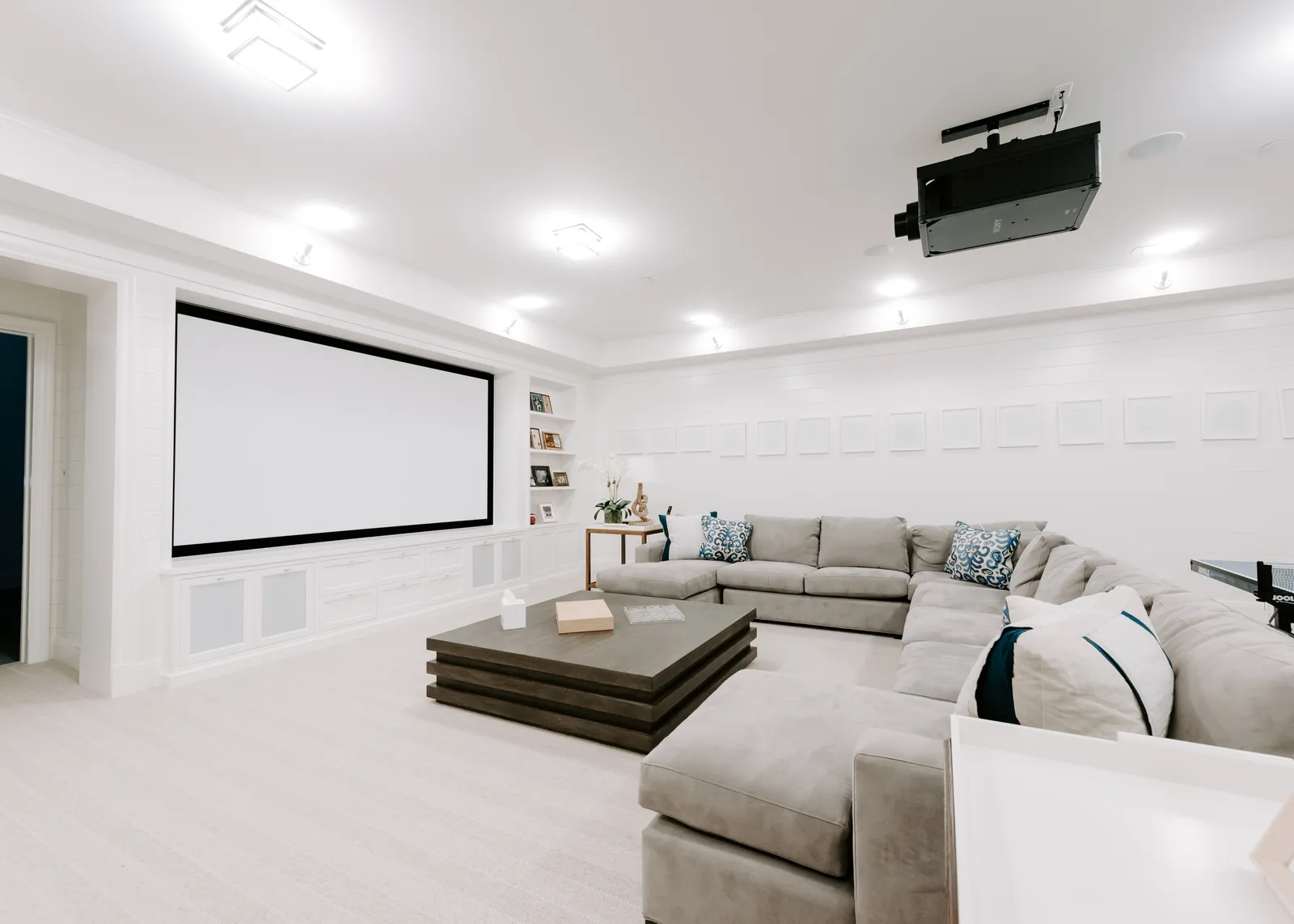 Bright home theater with a projection screen and ceiling-mounted projector