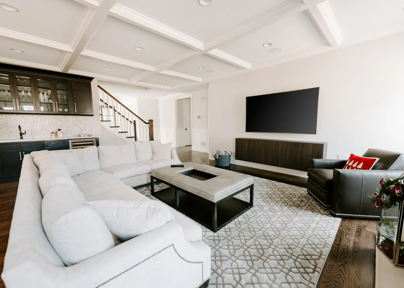 Television mounted above a fireplace in a bright living room