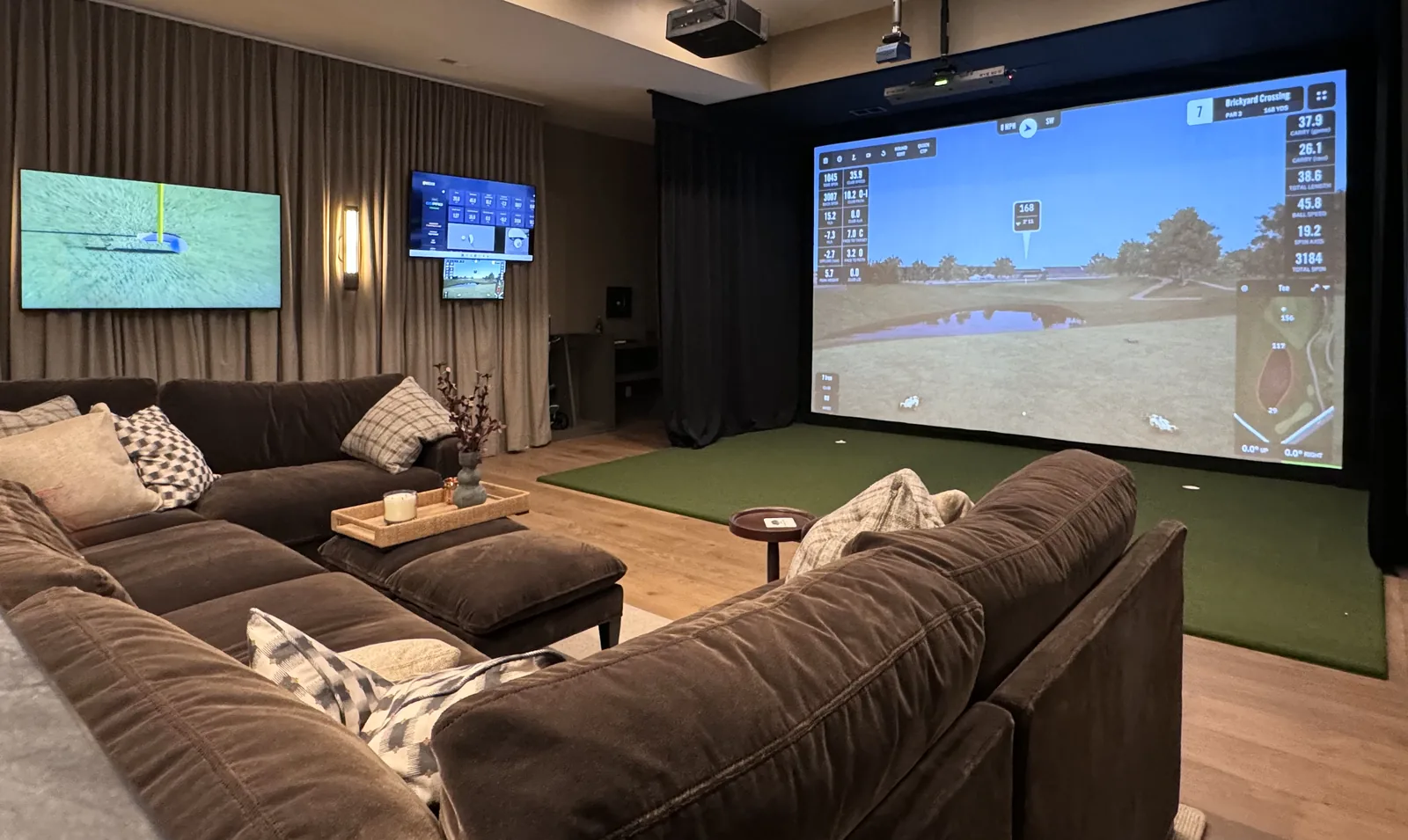 Custom residential golf simulator room with an impact screen, hitting turf, and integrated lighting