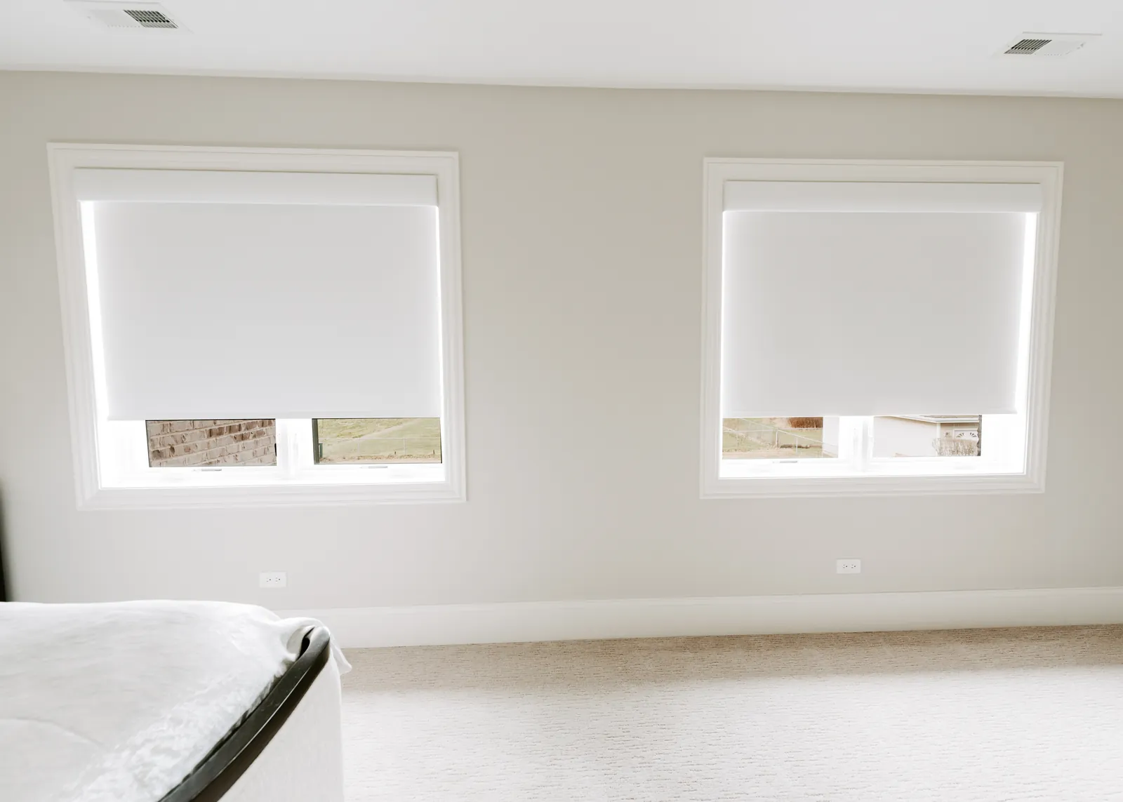 Motorized window shades installed across a row of windows
