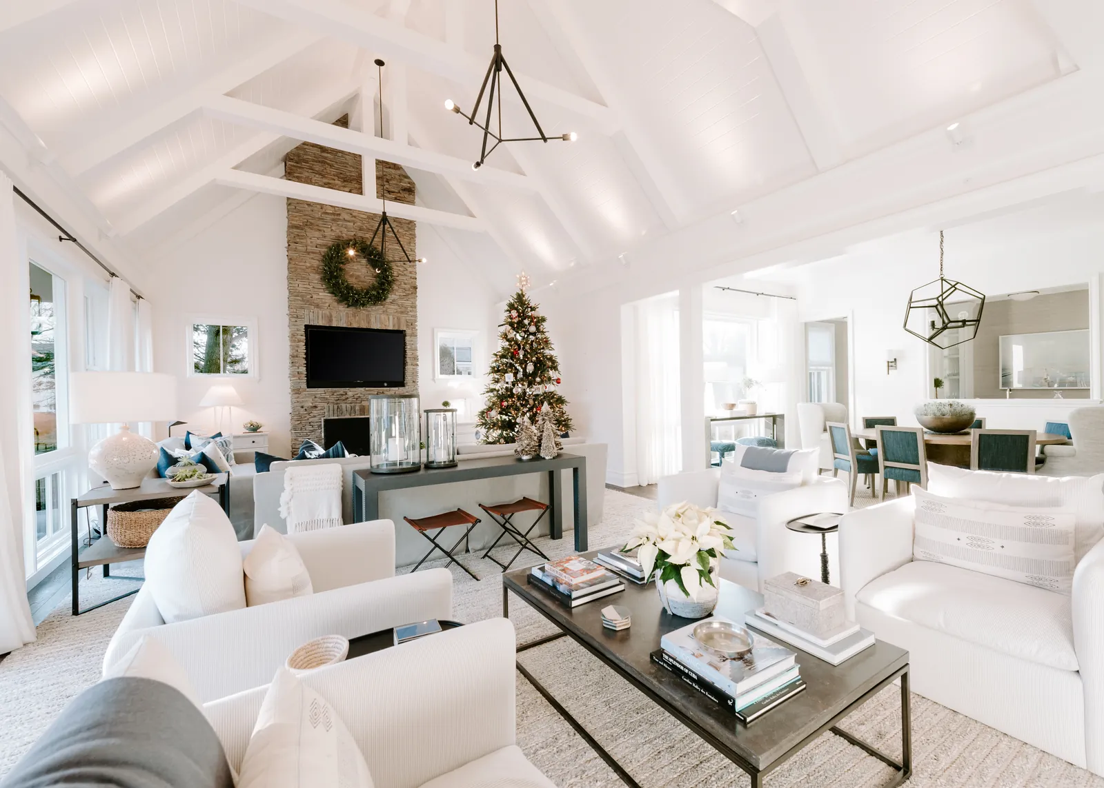 Bright living space with integrated television, lighting, and window treatments